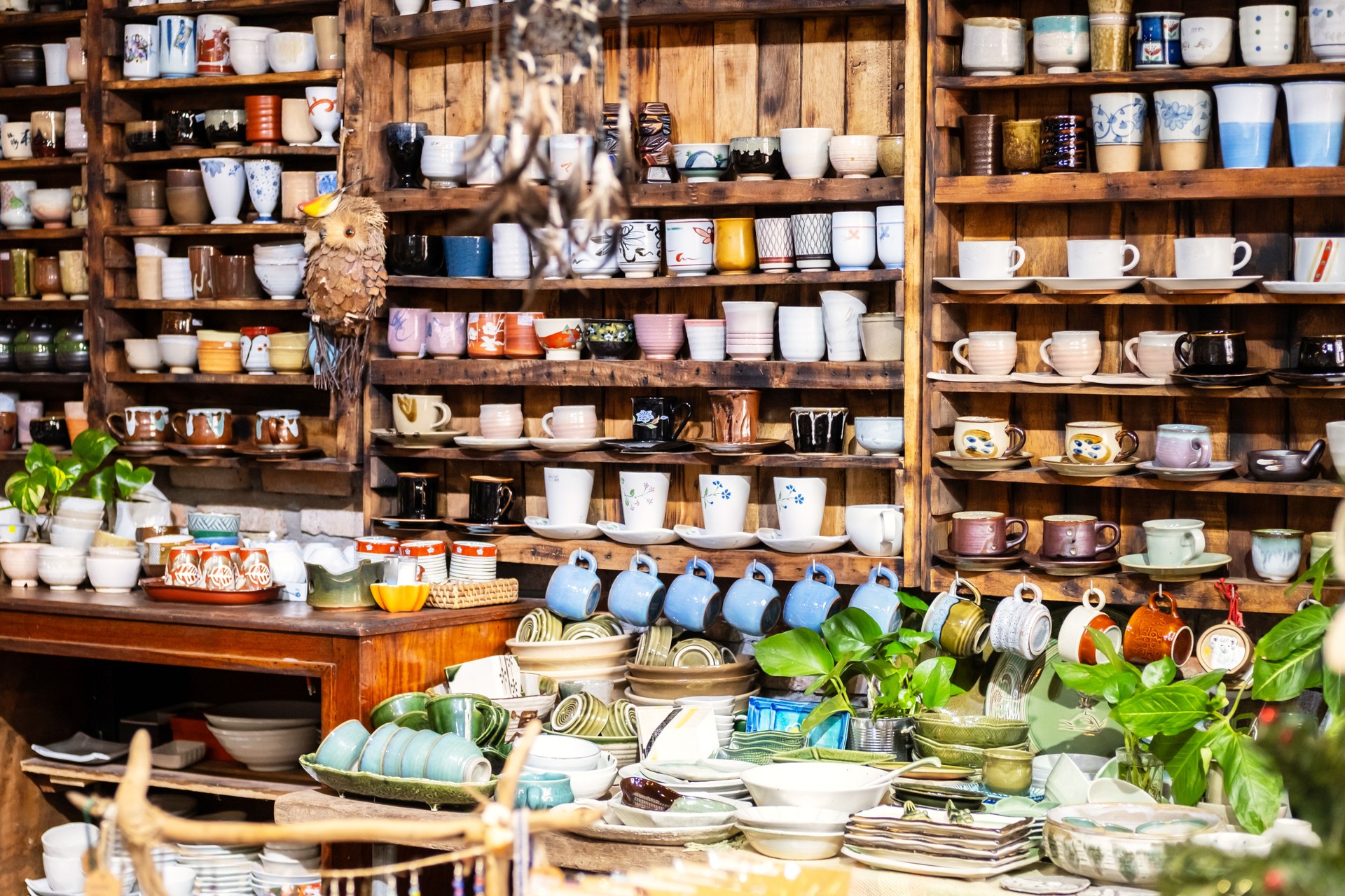 Small Store With Many Pottery Ceramic Standing On Shelves.